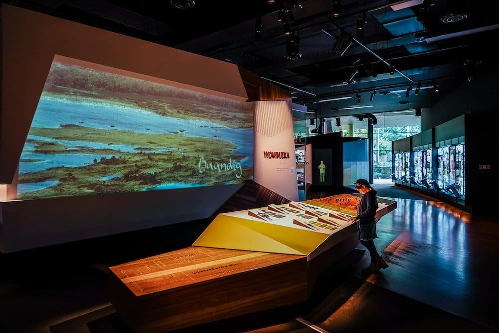 A large screen displays photos and videos about the indigenous culture and history of Australia.