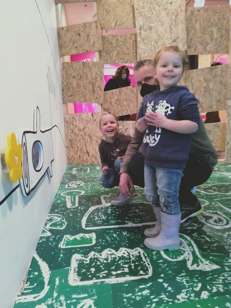 Plans for the planet NGV exhibition childrens gallery father with daughters enjoying the interactive exhibit